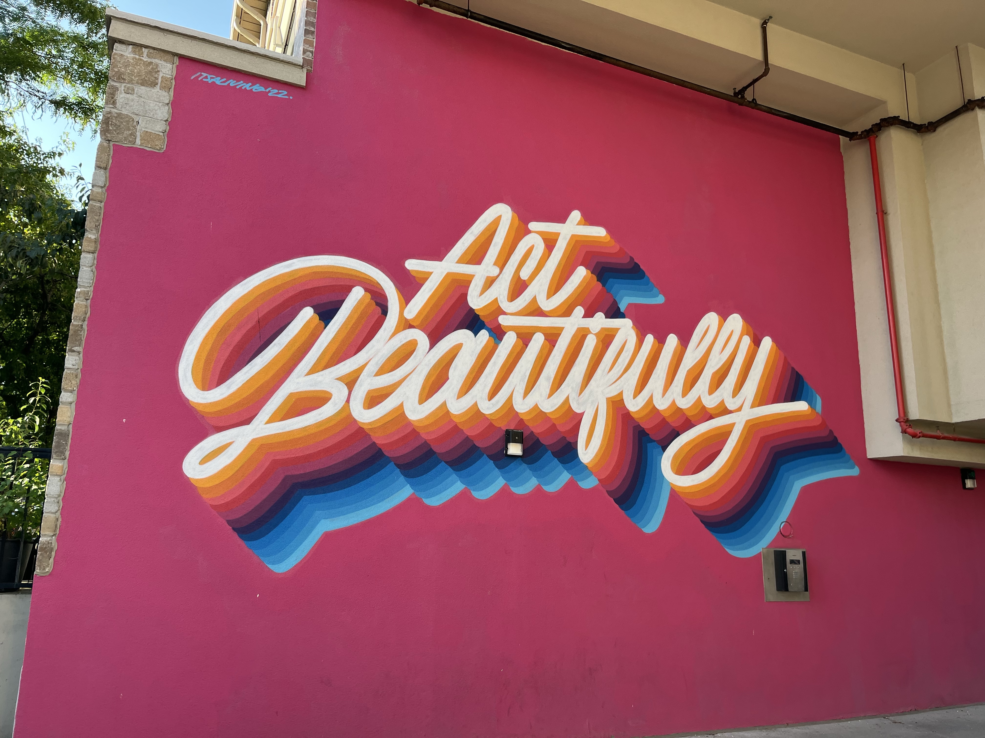 A mural with the words "Act Beautifully" on Ossington Avenue in Toronto